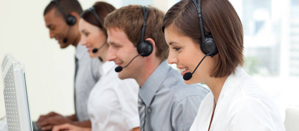 row of smiling contact center agents with headsets