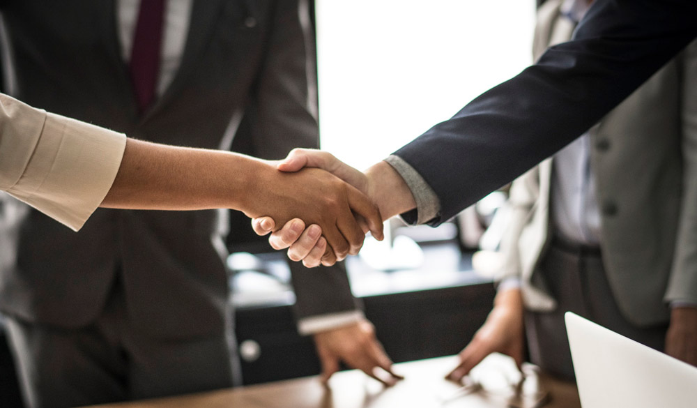 businesspeople shaking hands at meeting