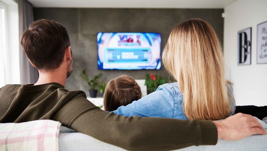 family watching tv on the couch