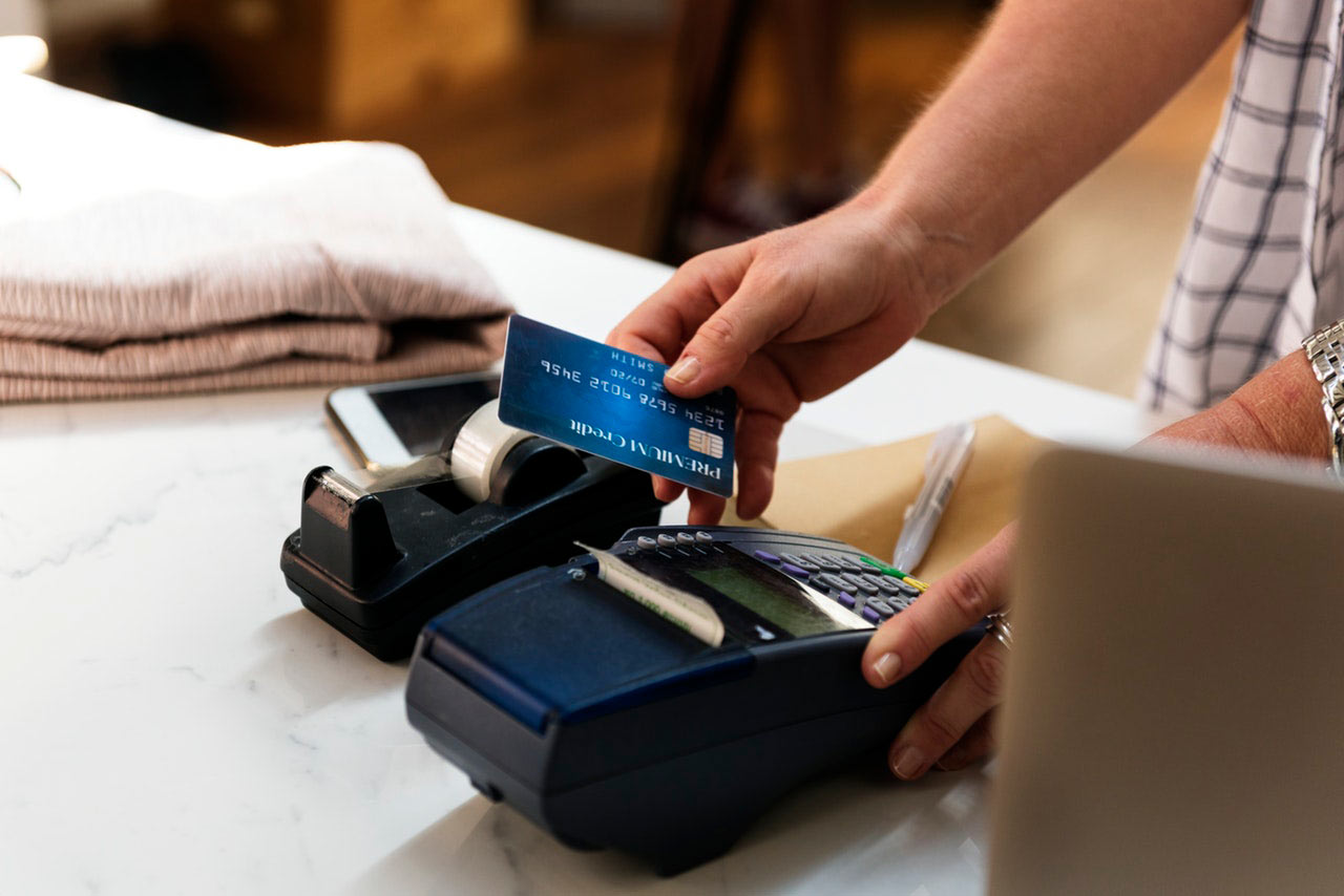 woman swiping credit card