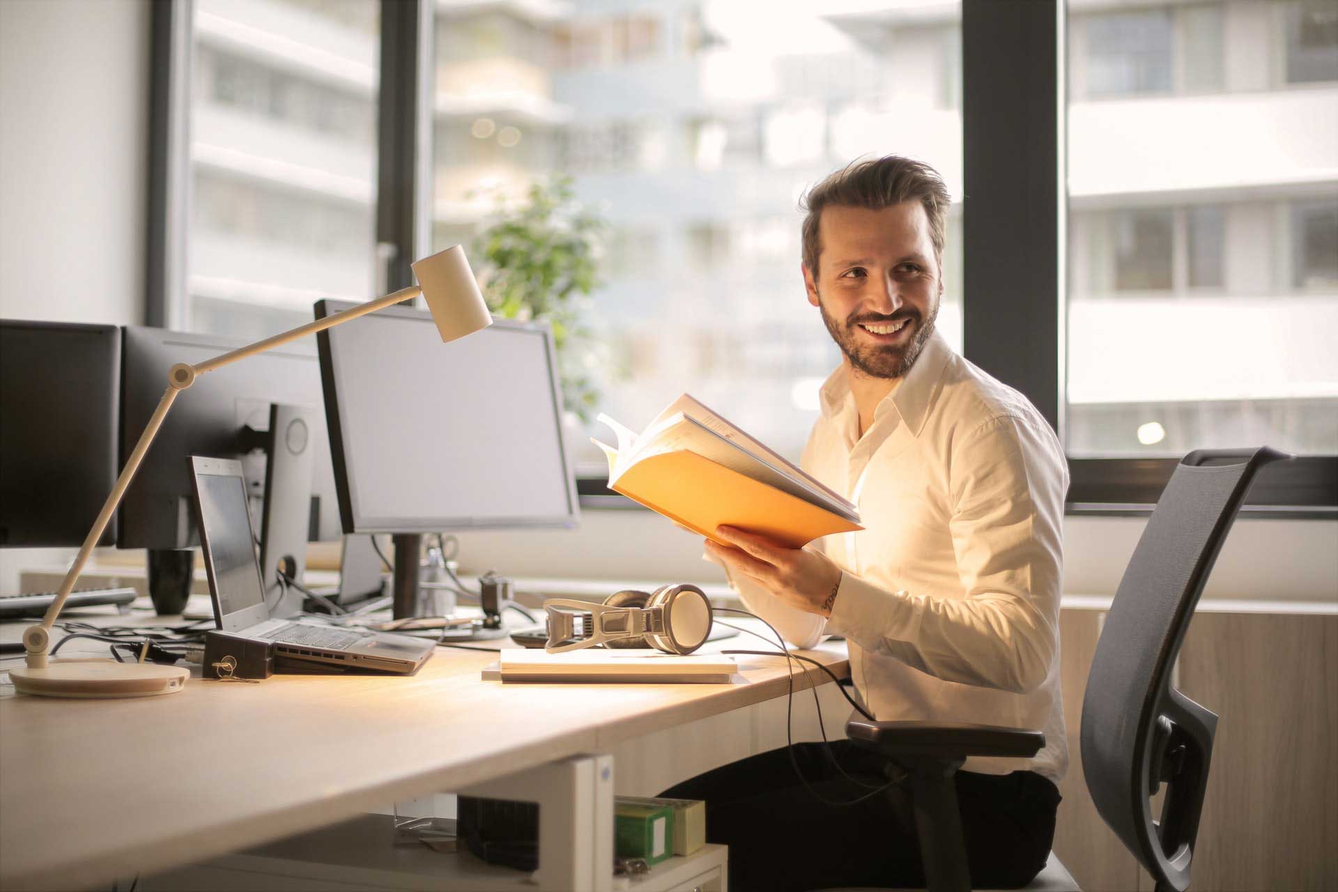 man at desk reading over files