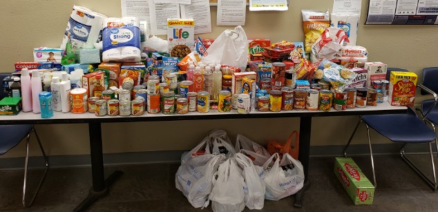 food pantry donations stacked on table