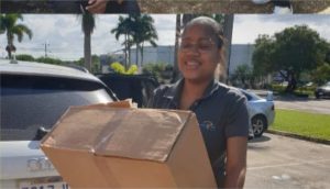 radius employee holding box in parking lot