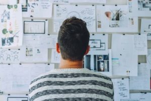 man looking at brainstorming wall