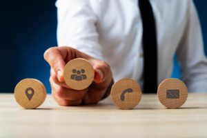 businessman holding wooden icons