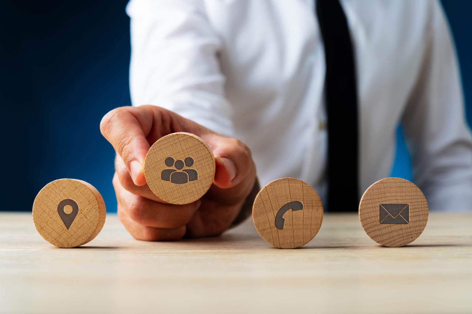 businessman holding wooden icons