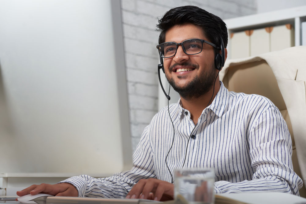 smiling male customer service agent with headset