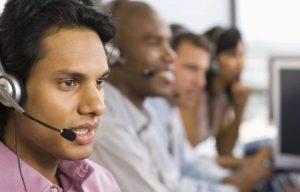 diverse contact center agents talking to customers with headsets