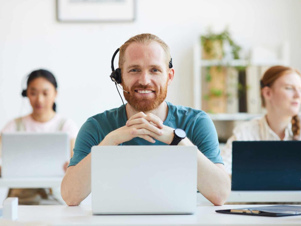 smiling call center agents talking with customers