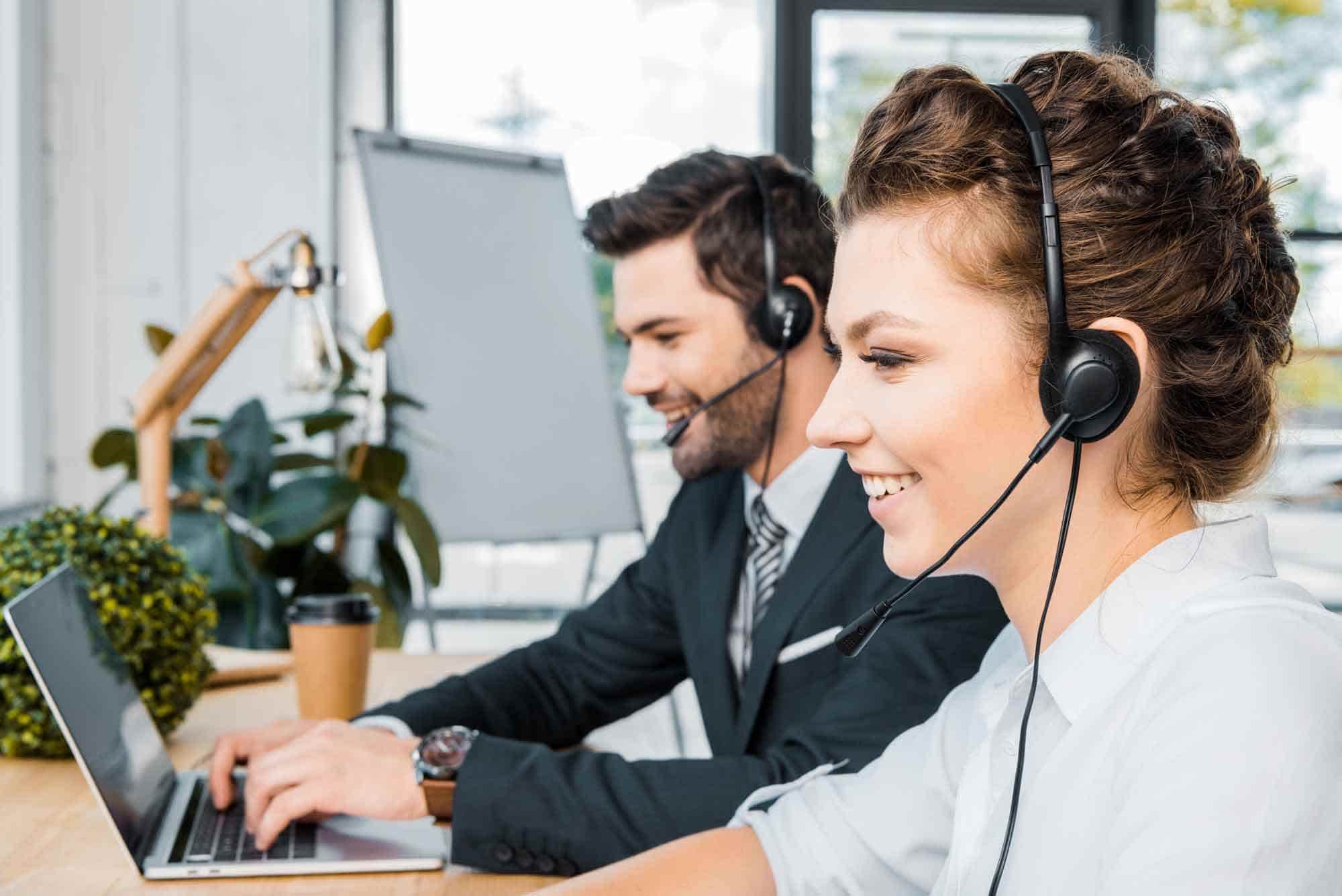 side-view-of-smiling-call-center-operators-at-work