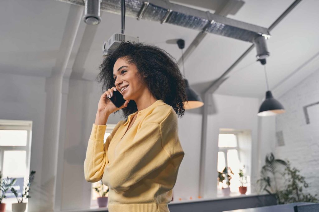 smiling contact center agent talking on the phone