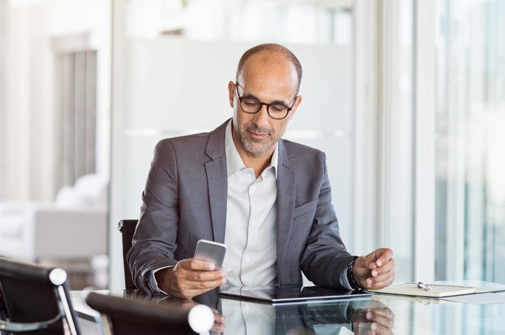 businessman looking at phone in the office