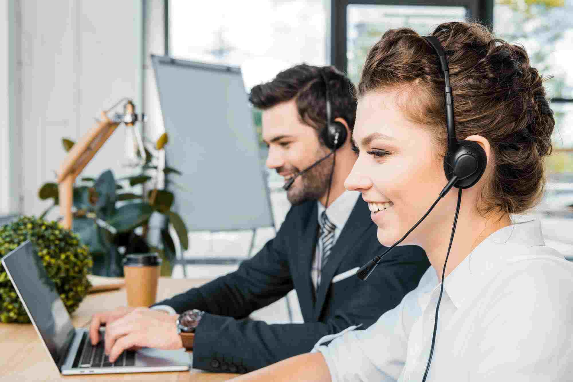 smiling call center operators with headsets