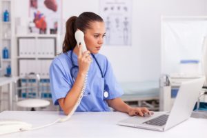healthcare professional scheduling an appointment over the phone
