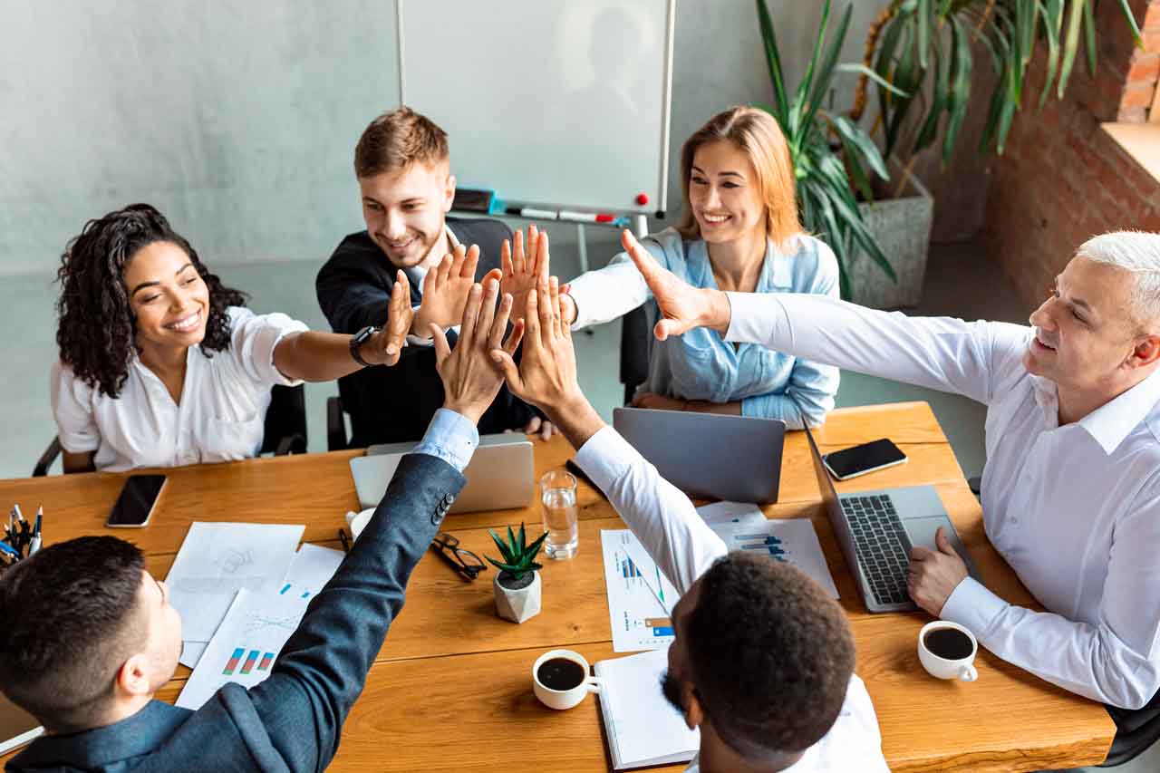 happy coworkers giving a group high five