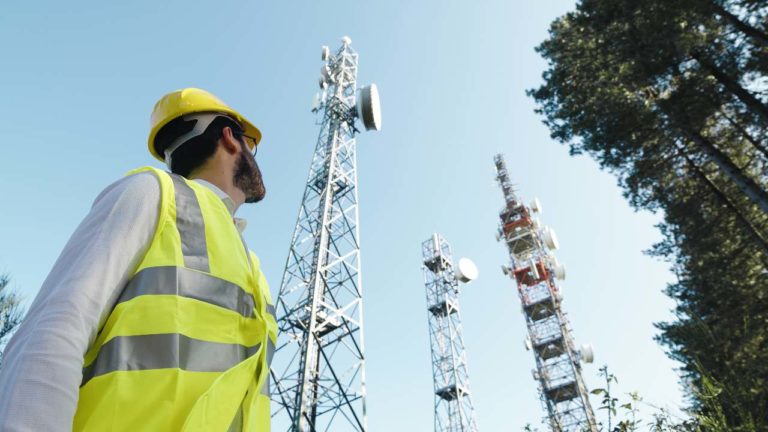 maintenance man looking at utility towers