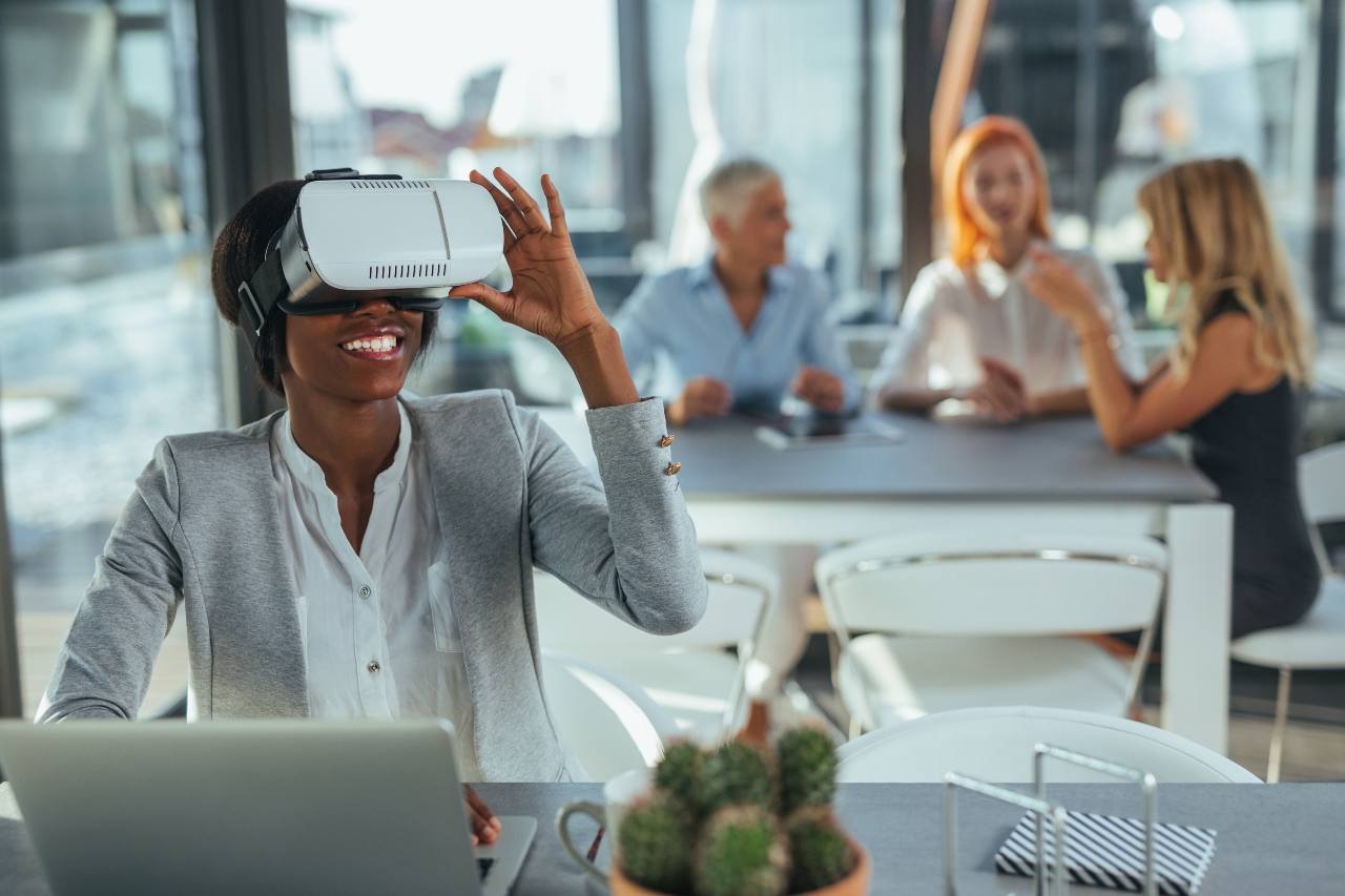 customer service representative smiling and wearing VR set in a modern office