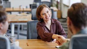 new customer experience agent shaking hands with recruiters