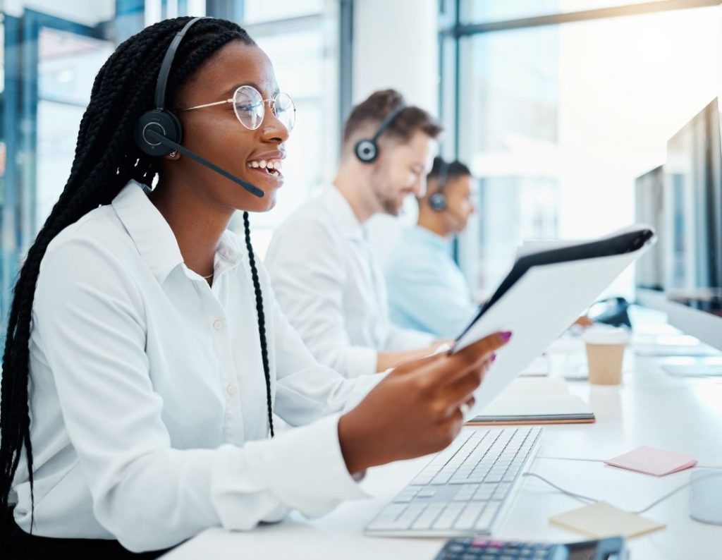 happy contact center agents talking on the phone in the office