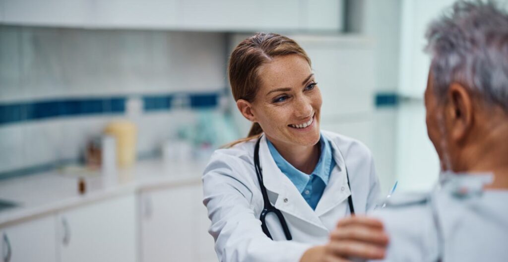 smiling doctor with her hand on a patient's shoulder