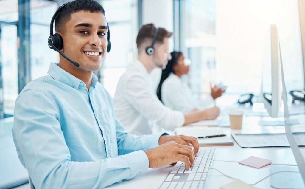 smiling customer service representative in a call center