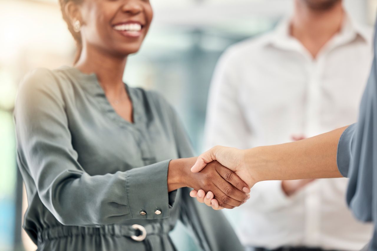 smiling customer shaking hands with employee