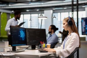 call center working in office at computer with coworkers